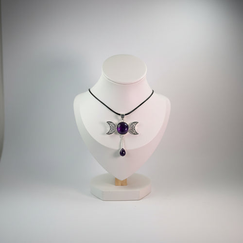 Triple moon amethyst pendant necklace with a purple amethyst stone displayed on a white jewellery bust