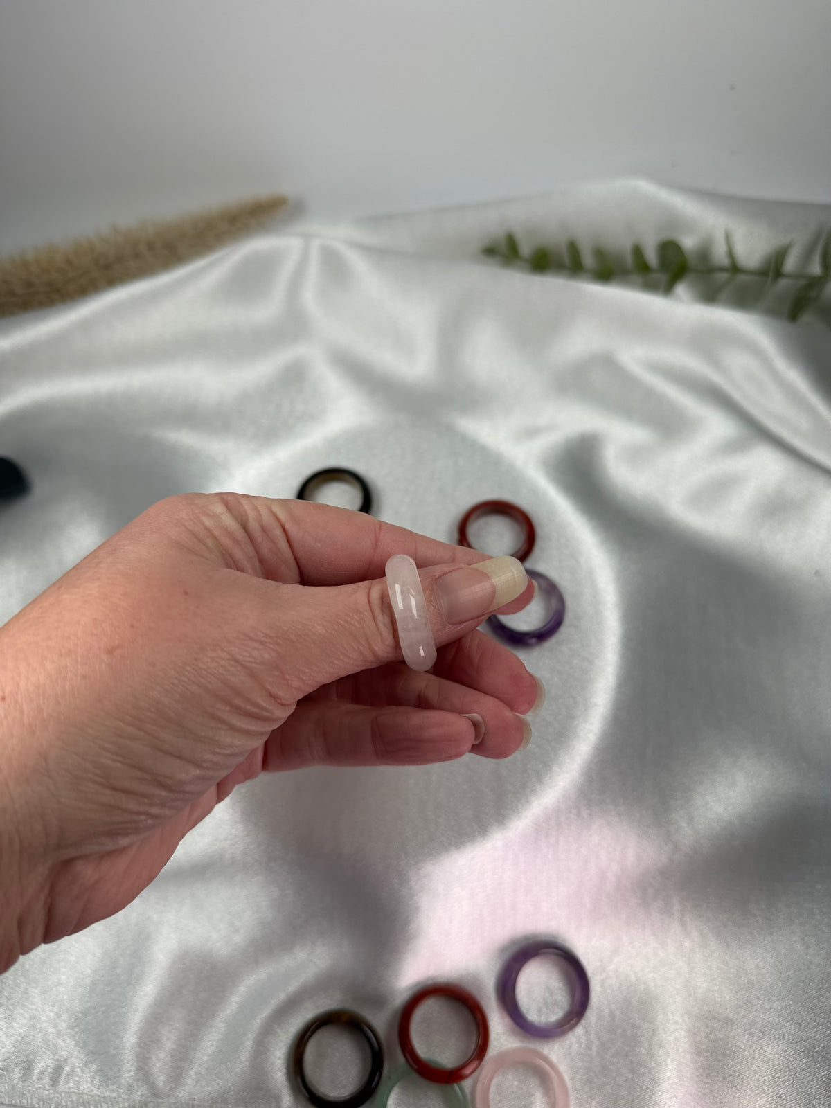 Treasured Energies crystal sphere holders displayed across multiple fingers