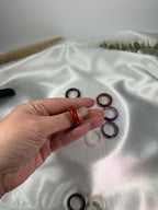 Treasured Energies crystal sphere holders fanned out and held in a hand