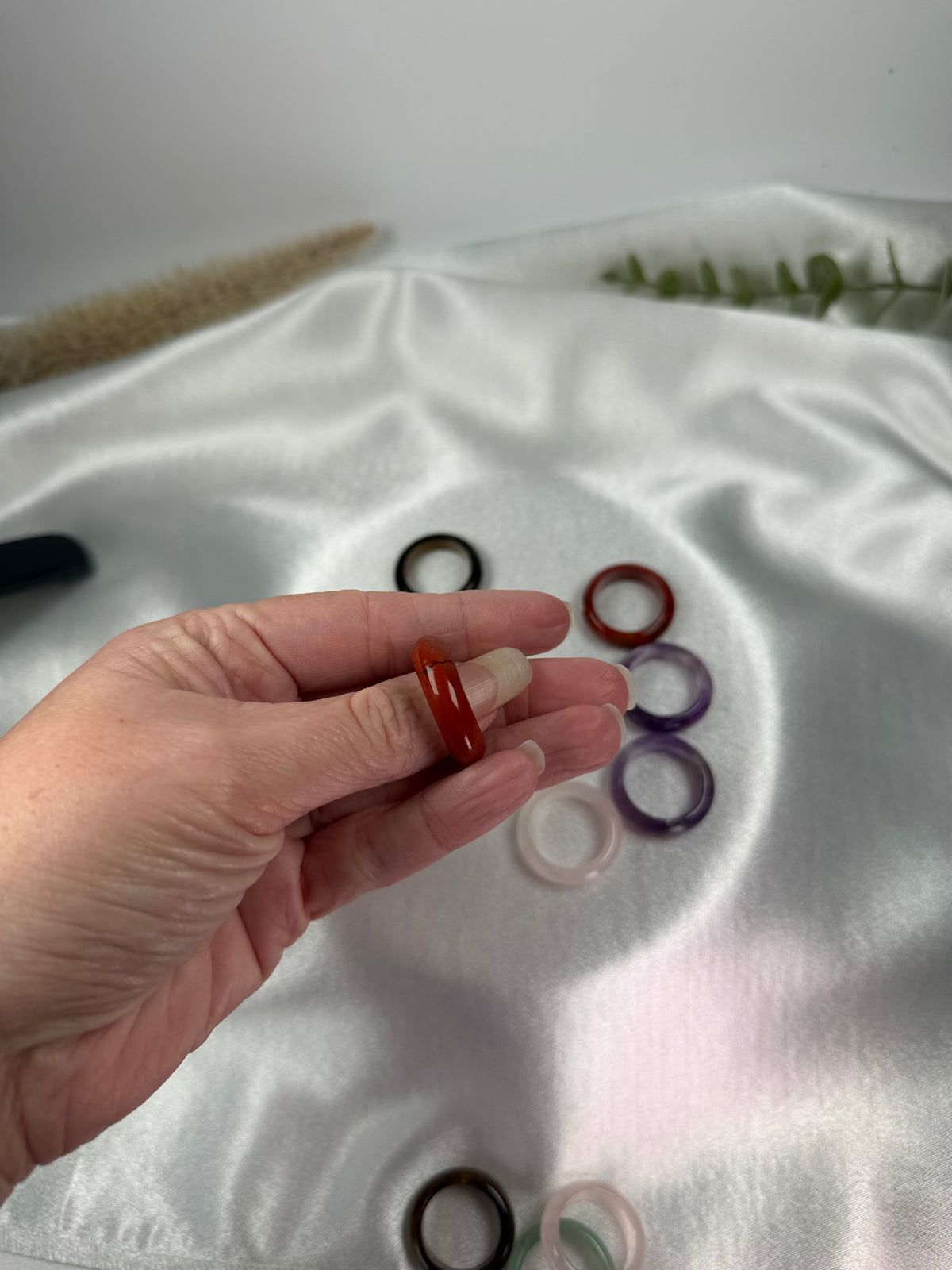 Treasured Energies crystal sphere holders fanned out and held in a hand