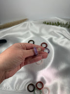 Treasured Energies crystal sphere holders worn on finger with others displayed in hand