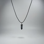Snowflake obsidian necklace with a dark crystal point pendant on a black cord