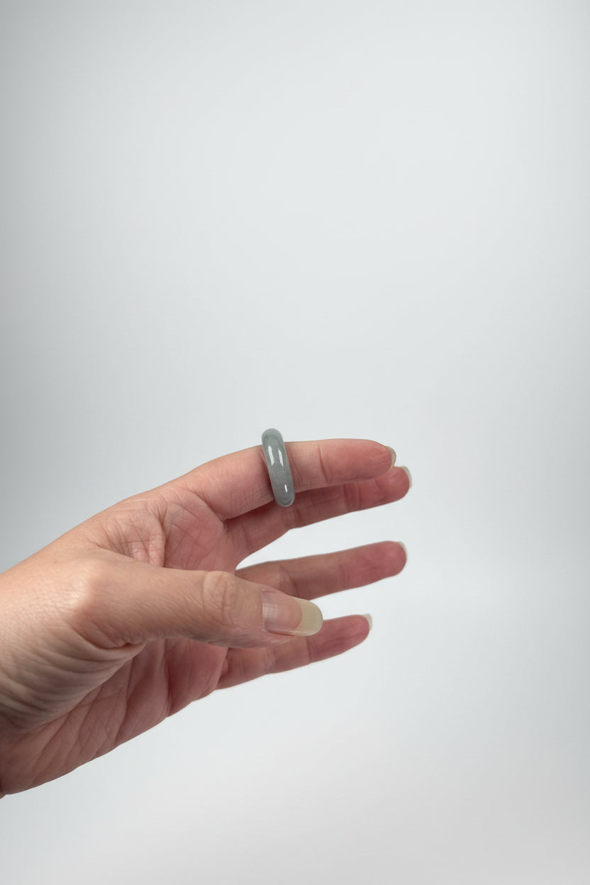 Treasured Energies crystal sphere holders worn on a hand against a light background