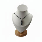 Snowflake obsidian necklace crystal point pendant displayed on a jewellery stand
