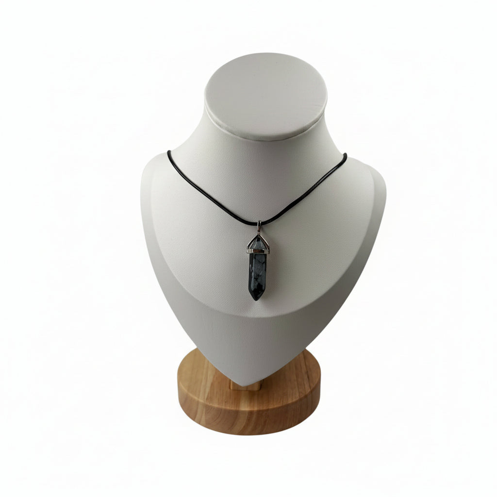 Snowflake obsidian necklace crystal point pendant displayed on a jewellery stand