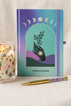 Cleaned-up Wellness Journal and crystal-filled pen photo
