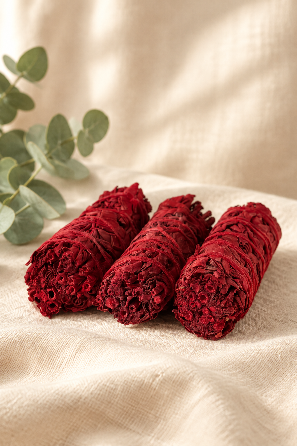 Dragon’s blood white sage sticks in a warm ivory linen setting