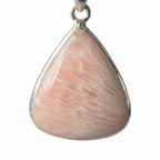 Treasured Energies scolecite teardrop crystal pendant on silver bail against a white background
