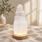 Tiered selenite crystal lamp on warm linen