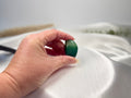 Treasured Energies tumbled Amazonite crystal held in hand, showing smooth blue-green polished stone surface.