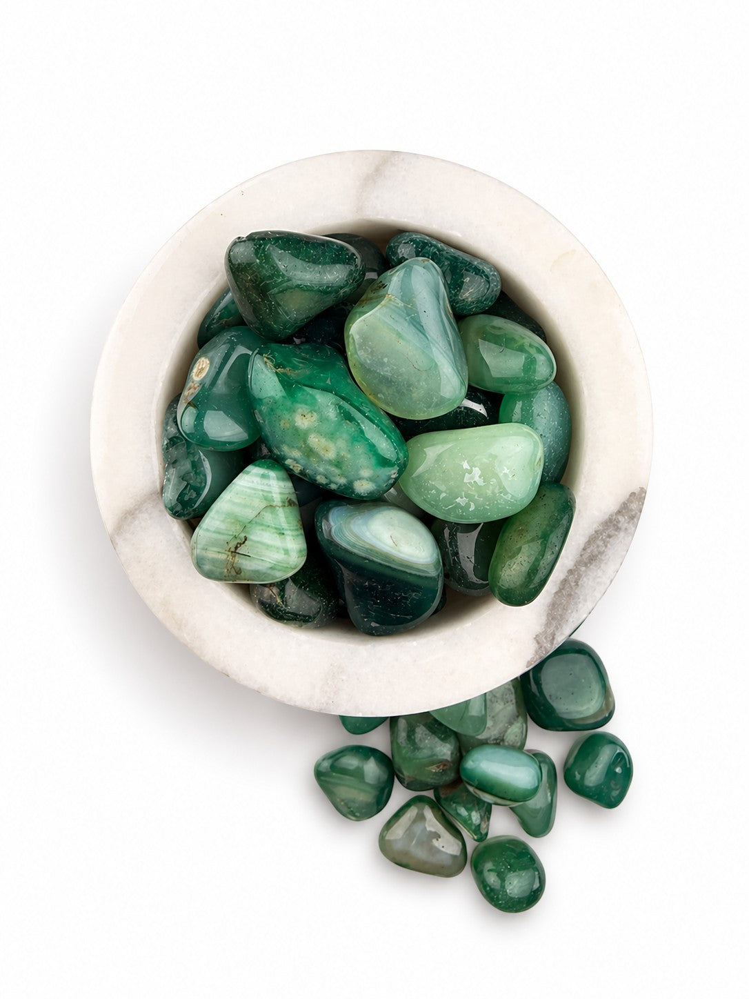 Treasured Energies polished green Amazonite tumbled stones in a white marble bowl on a white background.