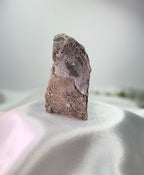 Treasured Energies freestanding amethyst cluster showing the raw, textured grey and brown stone base