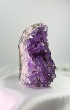 Treasured Energies freestanding amethyst cluster with deep purple crystalline points on a neutral surface