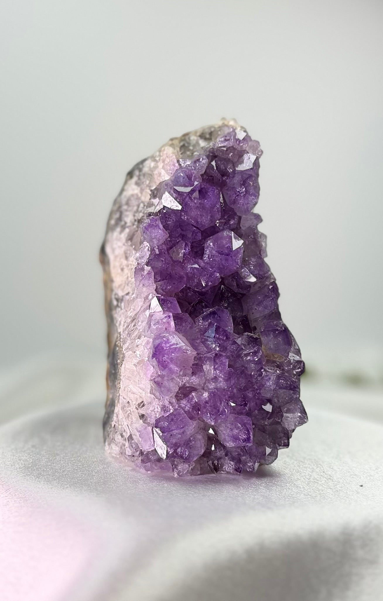 Treasured Energies freestanding amethyst cluster with deep purple crystalline points on a neutral surface