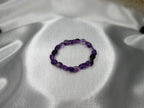 Treasured Energies amethyst bracelet crystal chip bracelet on a smooth silver satin background
