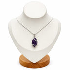 Treasured Energies amethyst natural crystal pendant wrapped in silver wire on a delicate chain displayed on a bust.