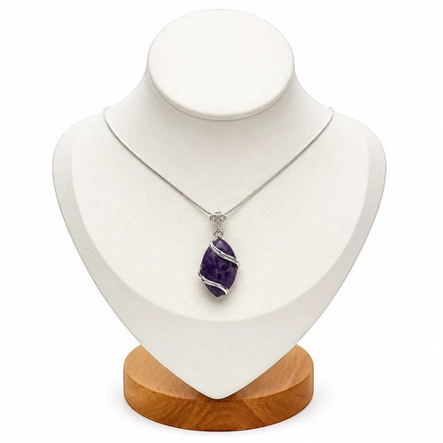 Treasured Energies amethyst natural crystal pendant wrapped in silver wire on a delicate chain displayed on a bust.