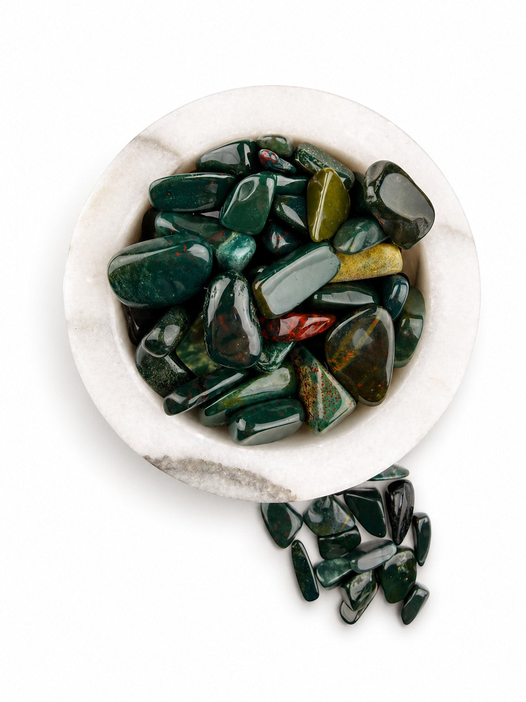 Treasured Energies polished bloodstone tumbled gemstones in a white marble bowl on a white background