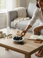 Treasured Energies polished natural bloodstone tumbled gemstones in a white marble bowl on a wooden coffee table