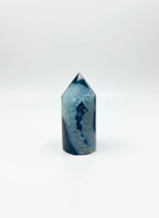 Treasured Energies blue agate crystal tower with a polished point and natural deep blue banded patterns.