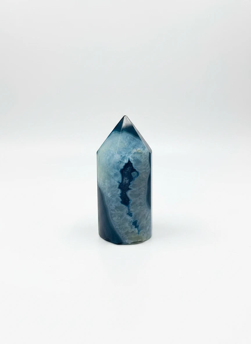 Treasured Energies blue agate crystal tower with a polished point and natural deep blue banded patterns.