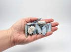 Treasured Energies natural blue kyanite crystal stones held in a palm for scale
