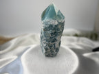Treasured Energies Blue Onyx crystal tower with a raw, textured base and a smooth, polished, translucent blue point.