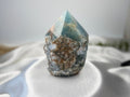 Treasured Energies Blue Onyx crystal tower with a raw, textured base and a smooth, polished pointed top.