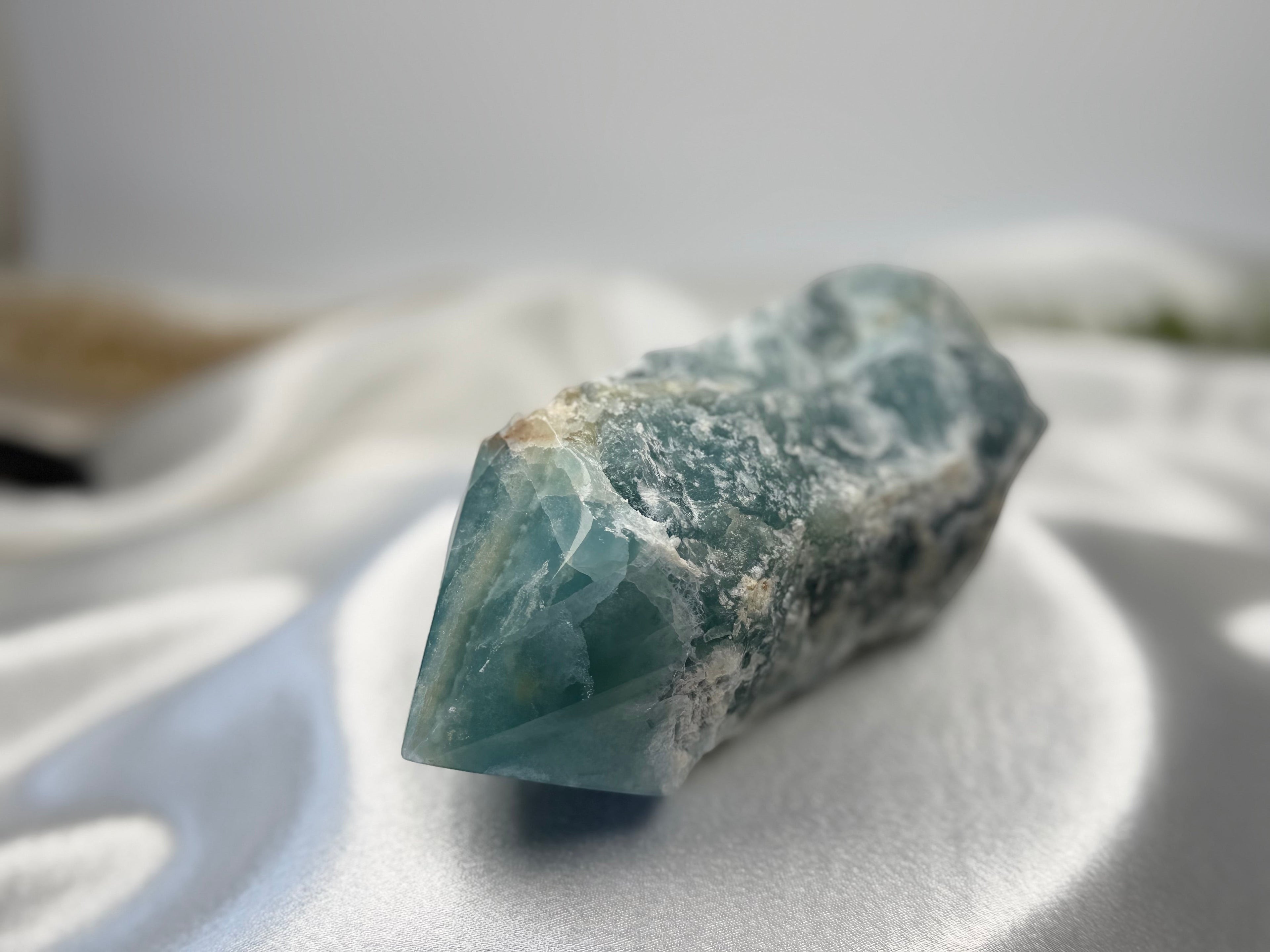 Treasured Energies blue onyx crystal tower with a raw, unpolished base and a smooth, faceted polished point.