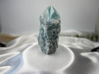 Treasured Energies blue onyx crystal tower with a raw, unpolished base and a smooth, faceted polished point.