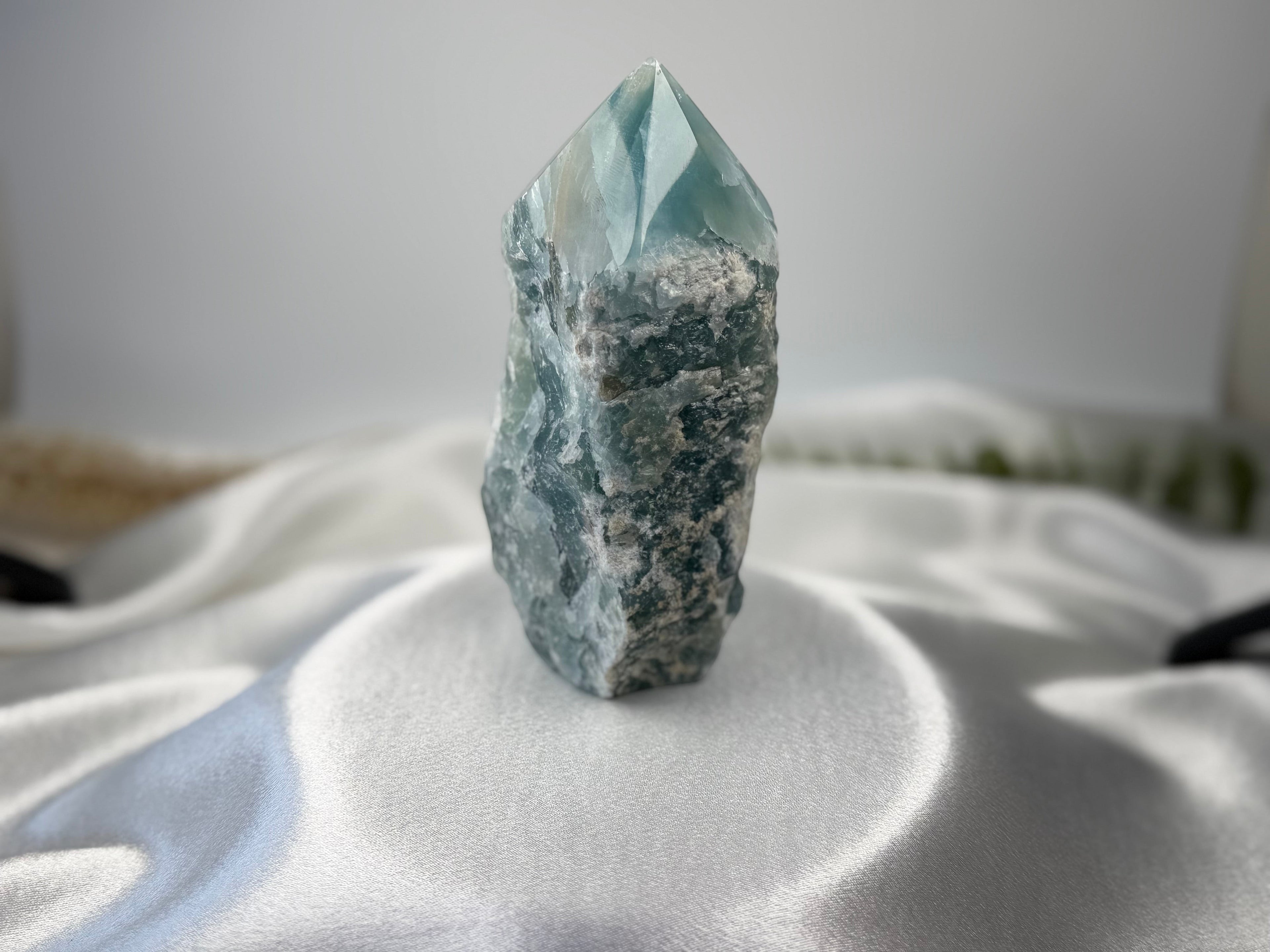 Treasured Energies blue onyx crystal tower with a raw, unpolished base and a smooth, faceted polished point.