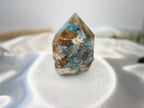Treasured Energies Blue Onyx crystal tower with a raw, unpolished base and a smooth, faceted polished point.