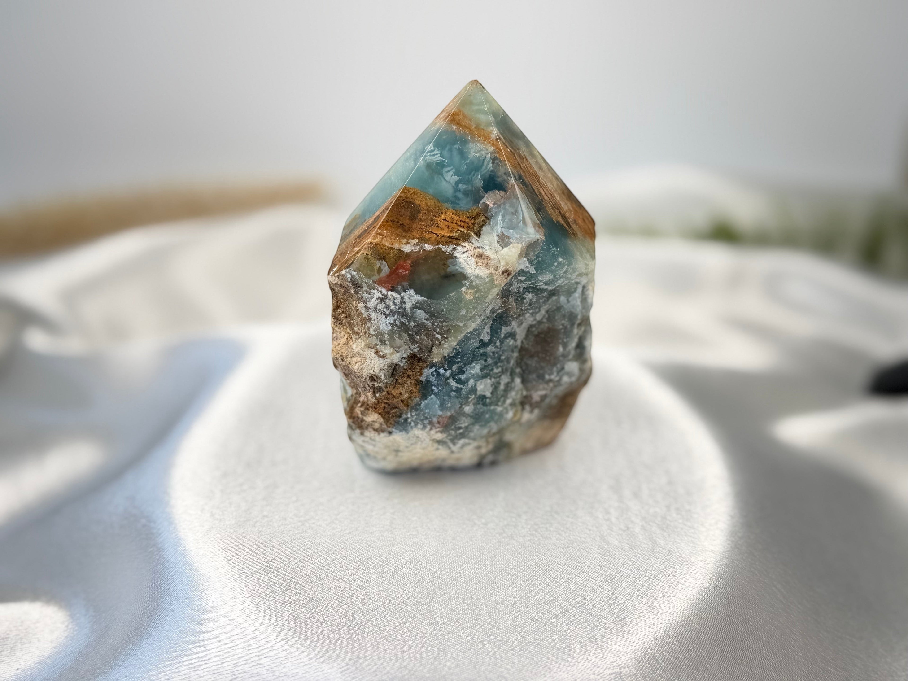 Treasured Energies Blue Onyx crystal tower with a raw, unpolished base and a smooth, faceted polished point.
