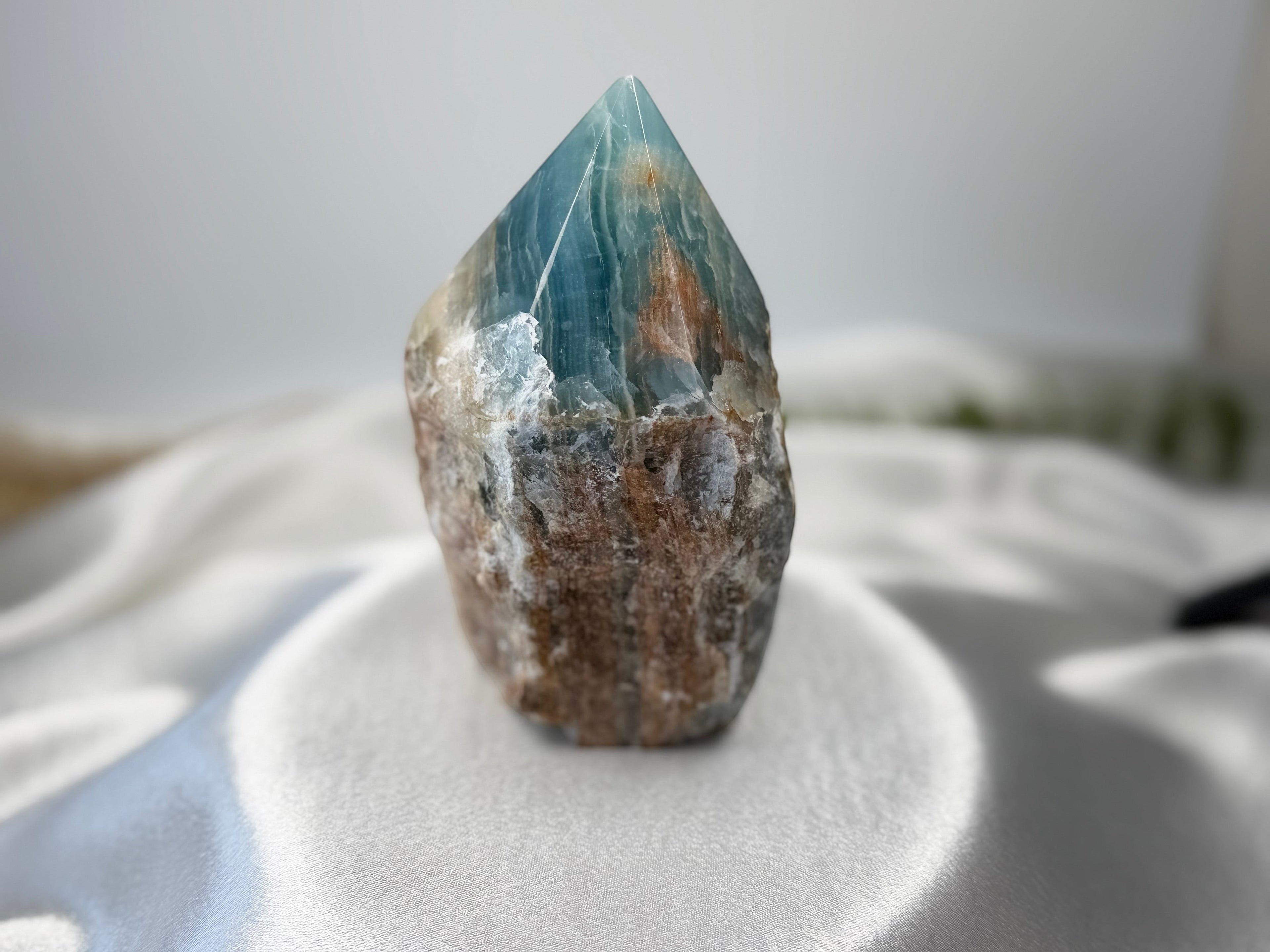 Treasured Energies Blue Onyx crystal tower with a raw, earthy base and a smooth, polished blue point for meditation.