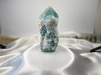 Treasured Energies Blue Onyx crystal tower with a raw, textured base and a smooth, polished faceted point.
