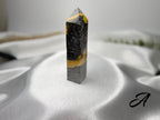 Treasured Energies Bumblebee Jasper crystal tower with striking black, grey, and vibrant yellow banded patterns.