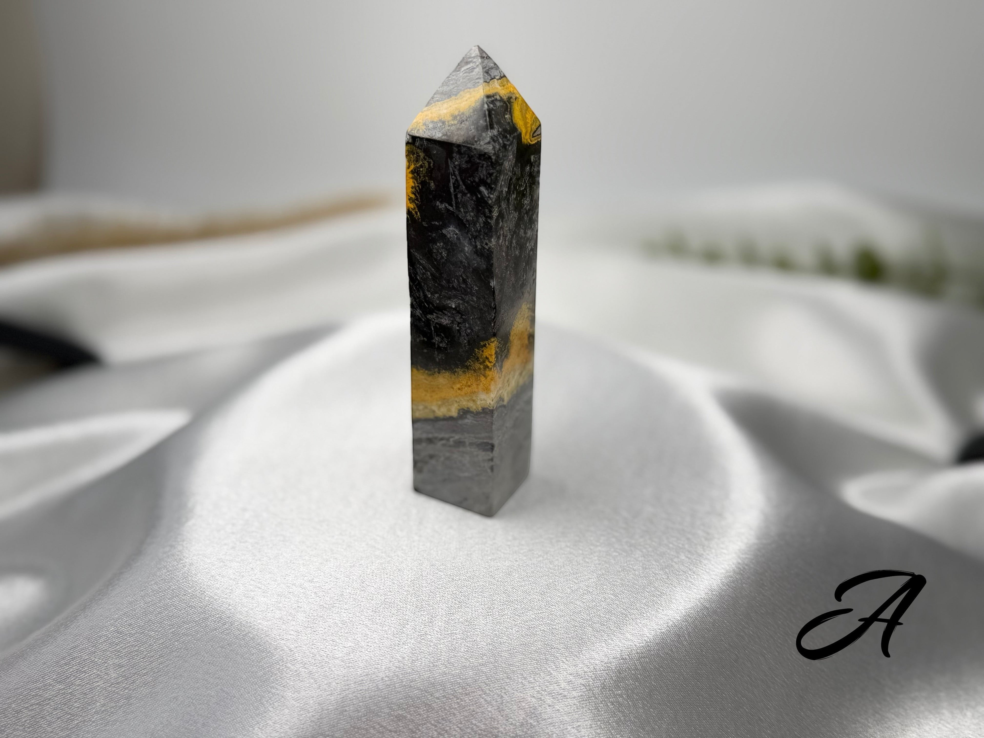 Treasured Energies Bumblebee Jasper crystal tower with striking black, grey, and vibrant yellow banded patterns.