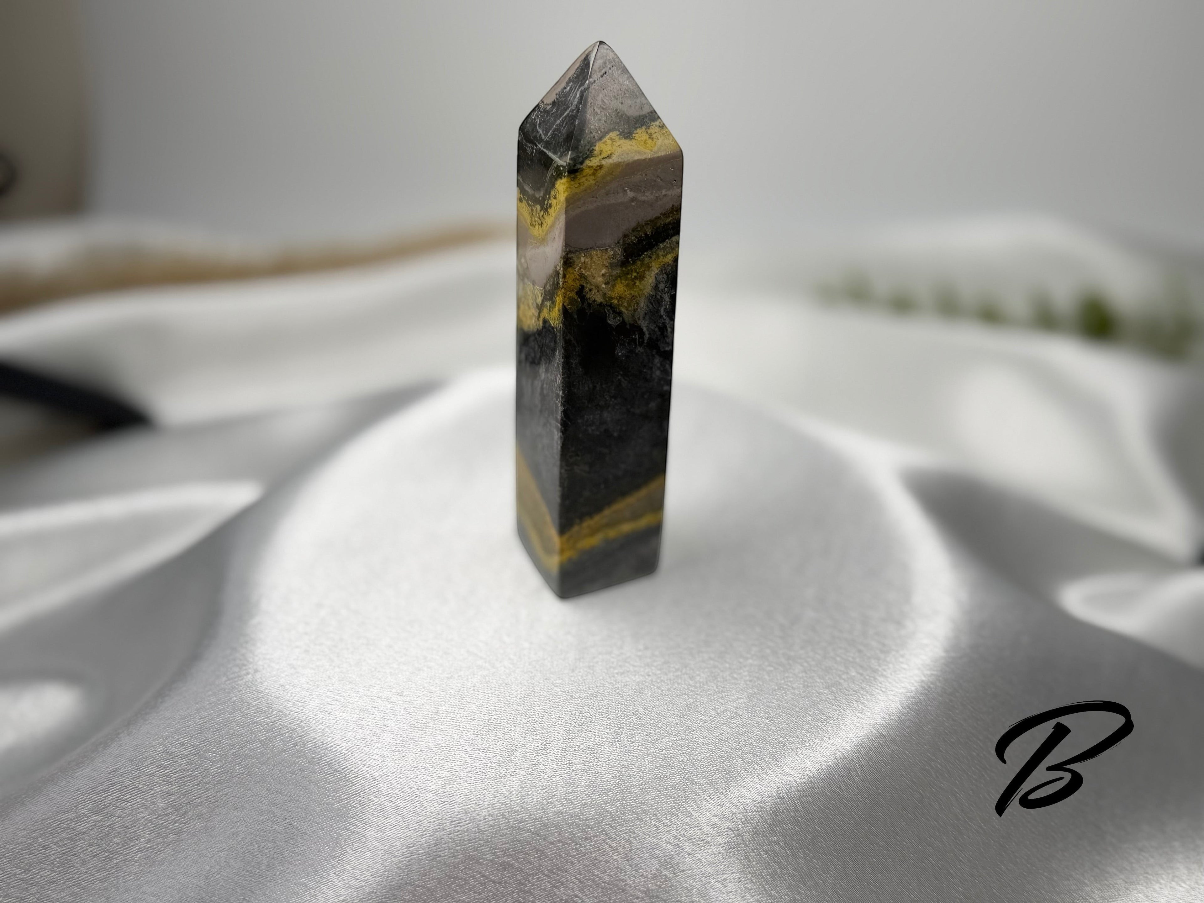 Treasured Energies Bumblebee Jasper crystal tower with distinct yellow, black, and grey banded volcanic layers.