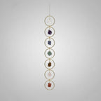 Treasured Energies 7 Chakra crystal window hanging with raw gemstones in gold circles for boho home decor.