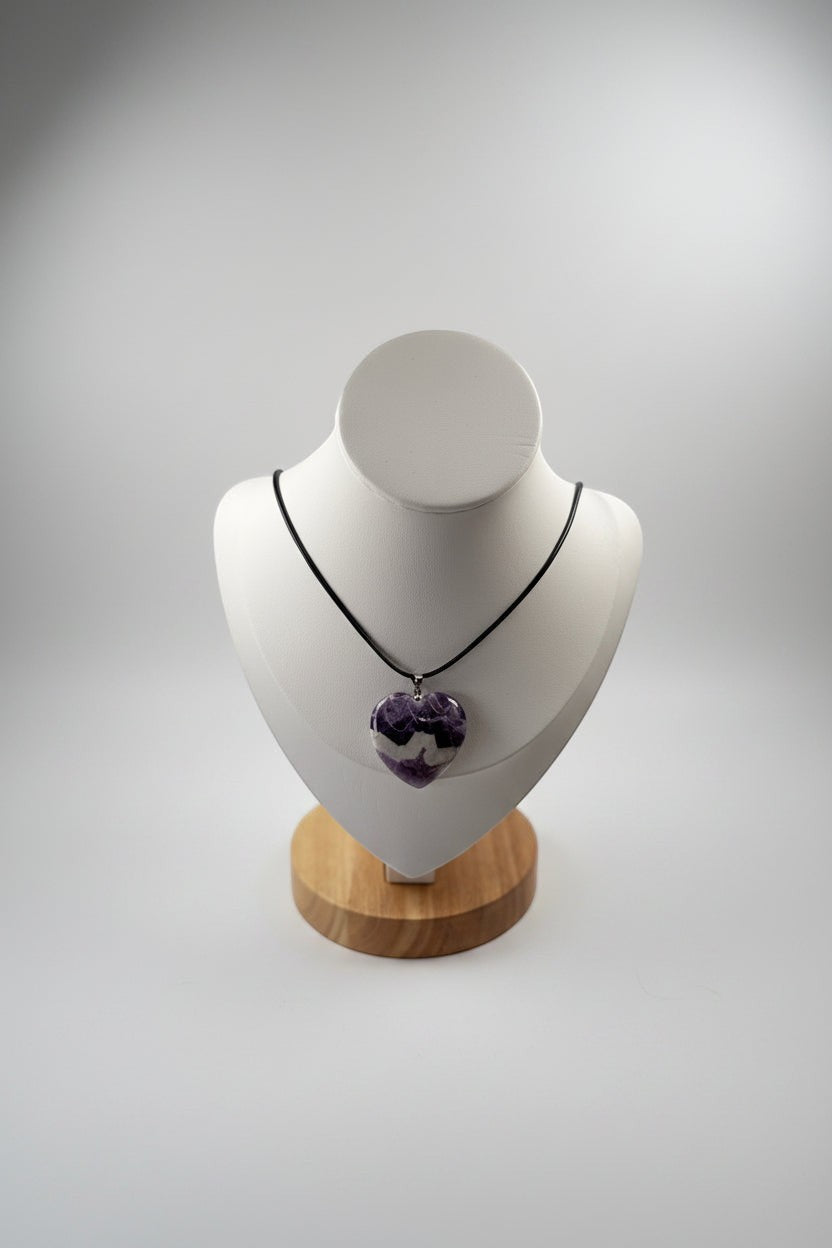 Treasured Energies heart-shaped chevron amethyst crystal pendant necklace on a white display bust