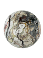 Treasured Energies polished Crazy Lace Agate crystal sphere with intricate swirling patterns in cream, grey, and brown.