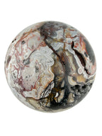 Treasured Energies polished Crazy Lace Agate crystal sphere with intricate swirling patterns in red, white, and grey.