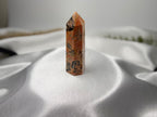 Treasured Energies Crazy Lace Agate crystal tower with intricate orange, brown, and cream swirling patterns.