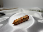 Treasured Energies Crazy Lace Agate crystal tower with intricate orange, cream, and brown swirling patterns.