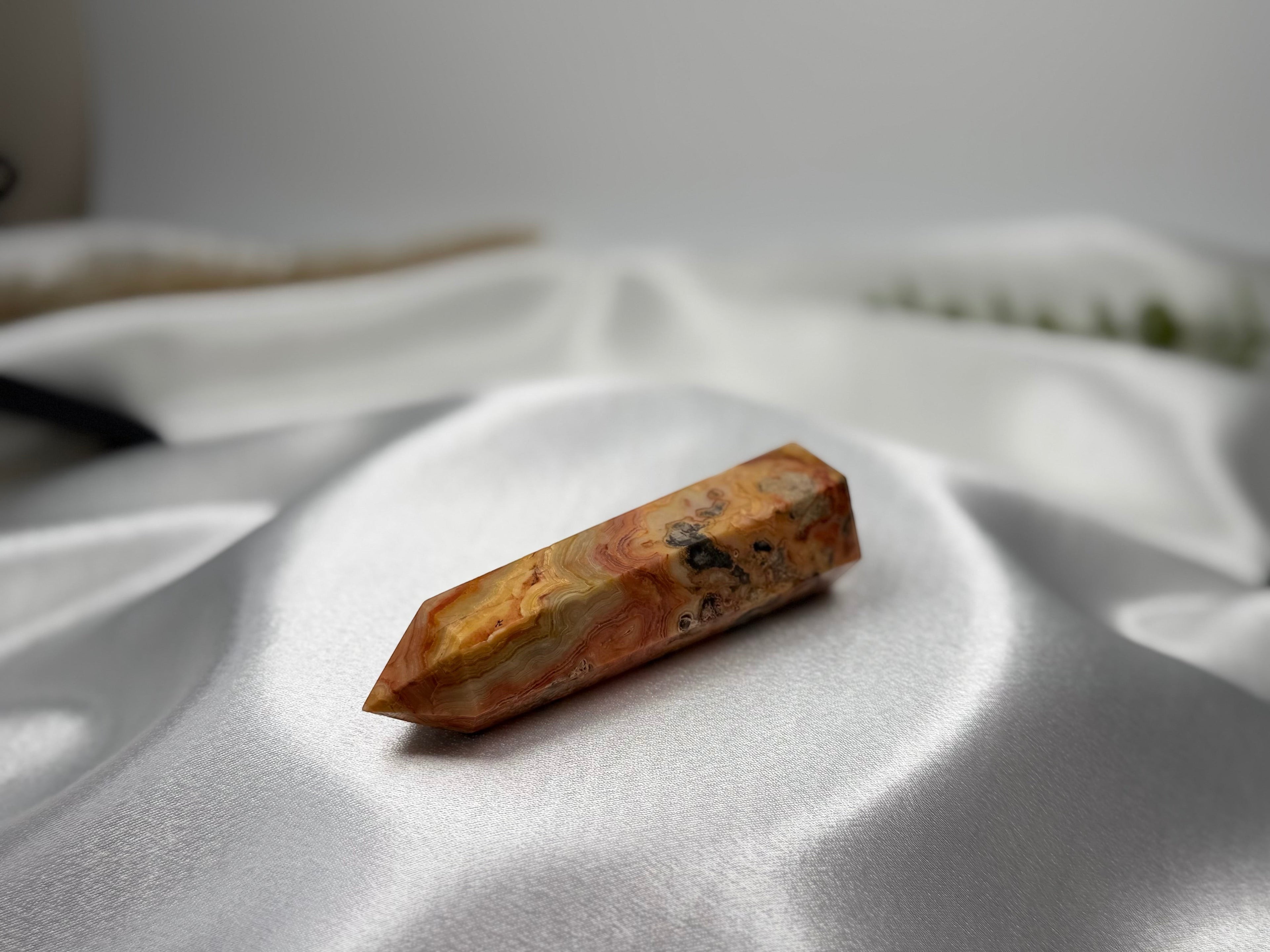 Treasured Energies Crazy Lace Agate crystal tower with intricate orange, cream, and brown swirling patterns.