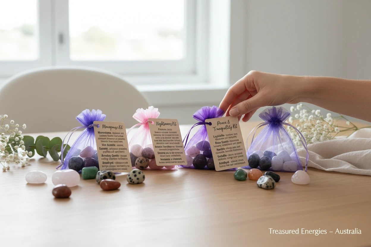 Treasured Energies crystal healing kits in organza pouches with tumbled stones on a wooden table for meditation