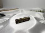 Treasured Energies Dragon Blood Jasper crystal tower with green and red patterns on a soft white satin background.