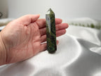 Treasured Energies Dragons Blood Jasper crystal tower held in a hand, showing green and red stone patterns.