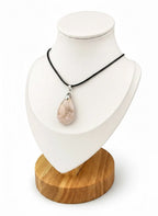 Treasured Energies teardrop flower agate pendant necklace on a black cord displayed on a white mannequin bust.