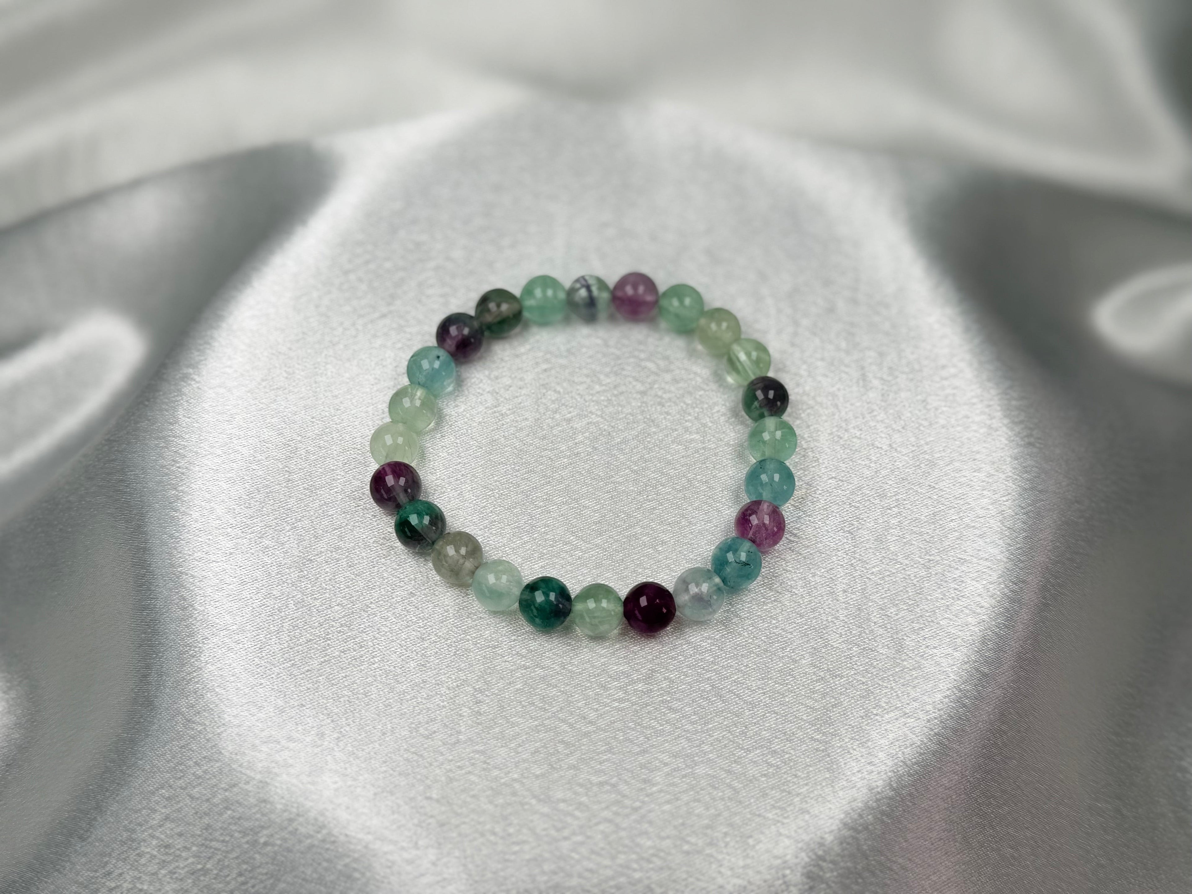 Treasured Energies fluorite gemstone beaded stretch bracelet with purple and green polished crystal beads on satin